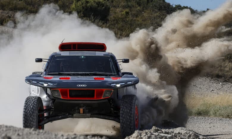 אאודי RS Q e-tron E2 בנסיעה בשטח עם אבק וחול מאחורי הרכב