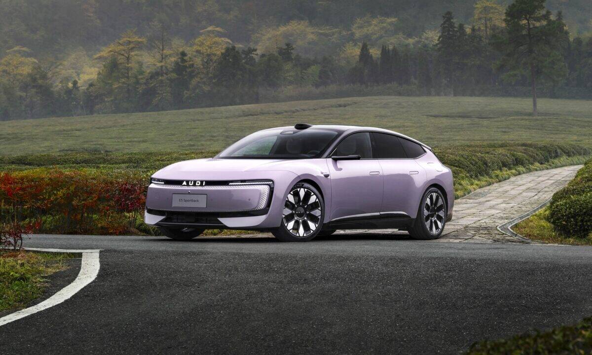 אאודי E5 ספורטבק בצבע סגול ורוד בהיר בנסיעה בנופים ירוקים וצבעוניים